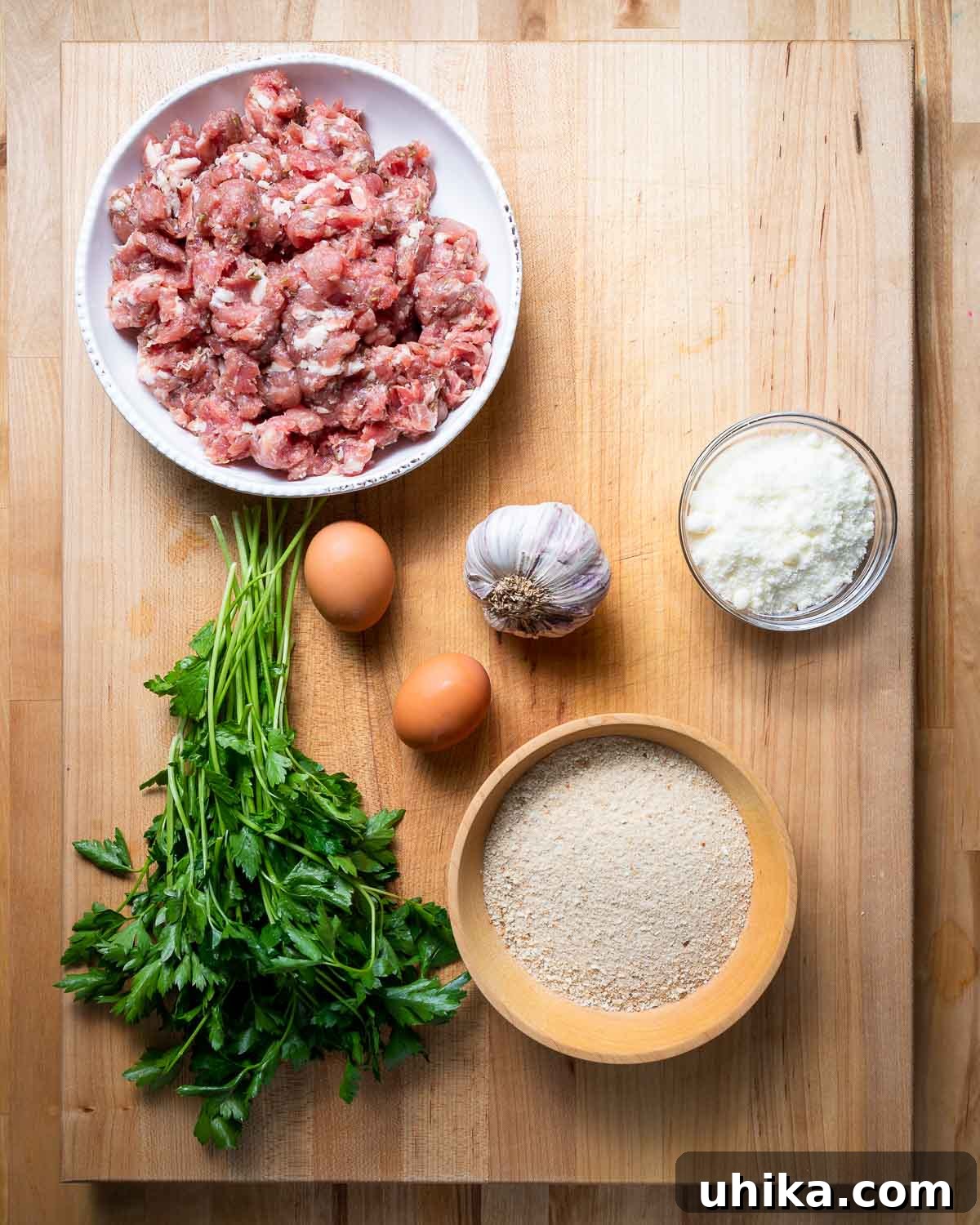Flavorful Italian Sausage Meatballs 3 Ingredients shown: bulk sausage, parsley, eggs, garlic, and Pecorino Romano cheese.