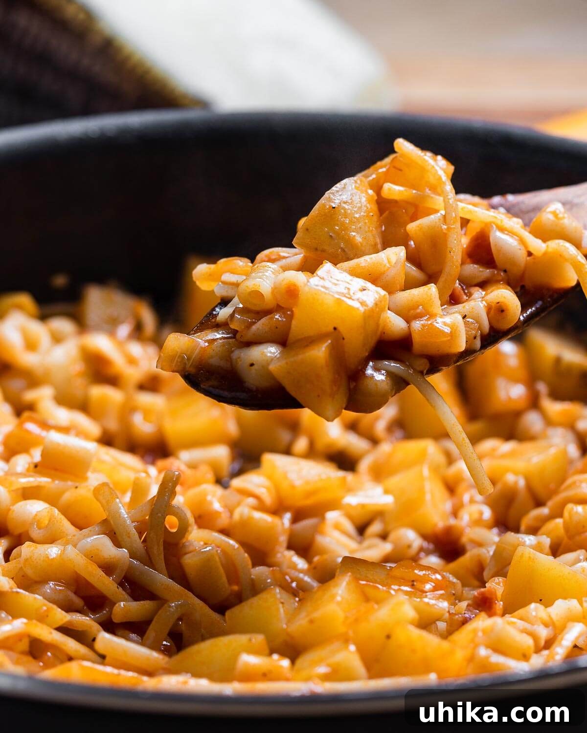 Pasta with Potatoes 2 A hearty portion of Pasta e Patate served in a rustic bowl, showcasing small pasta shapes mixed with tender, diced potatoes in a rich, lightly tomato-infused sauce, ready to be enjoyed.