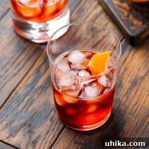 Featured image showing a Negroni cocktail on wood table.