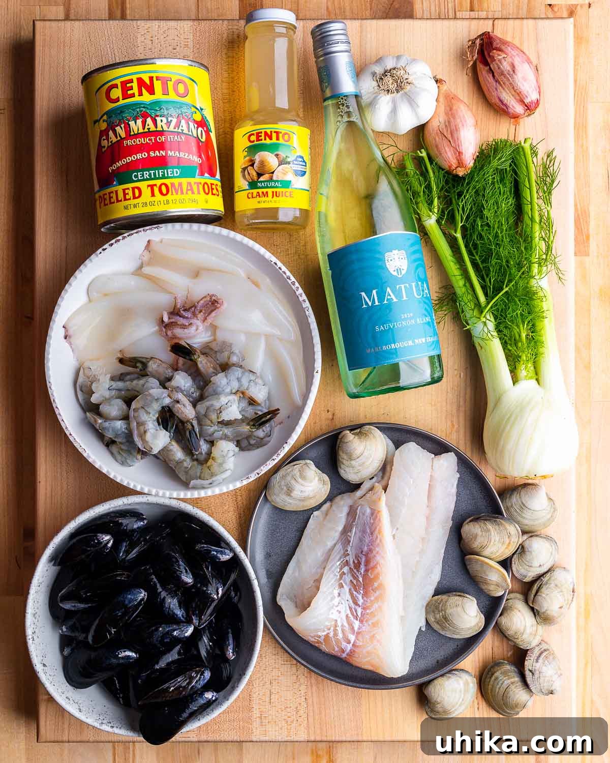 Hearty Italian Seafood Stew 3 Ingredients shown: canned plum tomatoes, clam juice, wine, garlic, shallots, fennel, mussels, shrimp, calamari, fish, and clams.