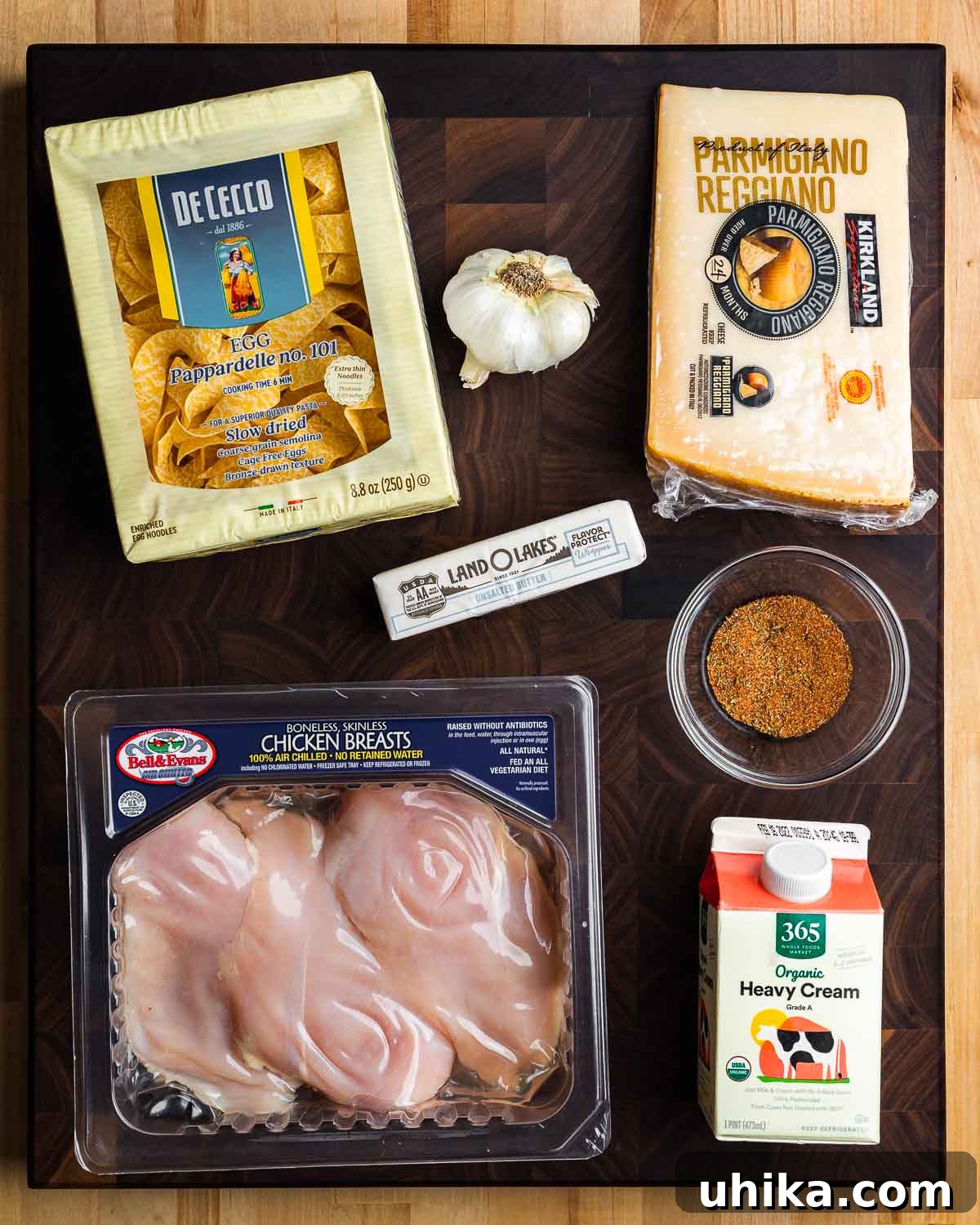 Decadent Chicken Alfredo Pasta 3 Ingredients for chicken alfredo pasta: egg pappardelle, minced garlic, grated Parmigiano Reggiano, unsalted butter, blackened spice, chicken breasts, and heavy cream.