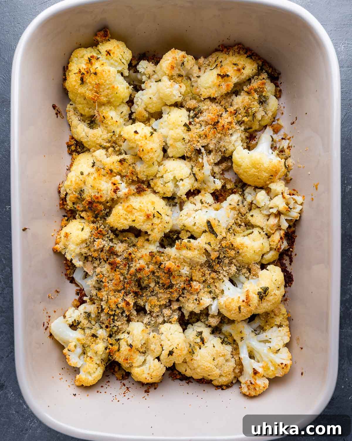 Golden Cauliflower Gratin 7 Baked cauliflower with cheese and breadcrumbs in a large baking dish, fresh out of the oven.