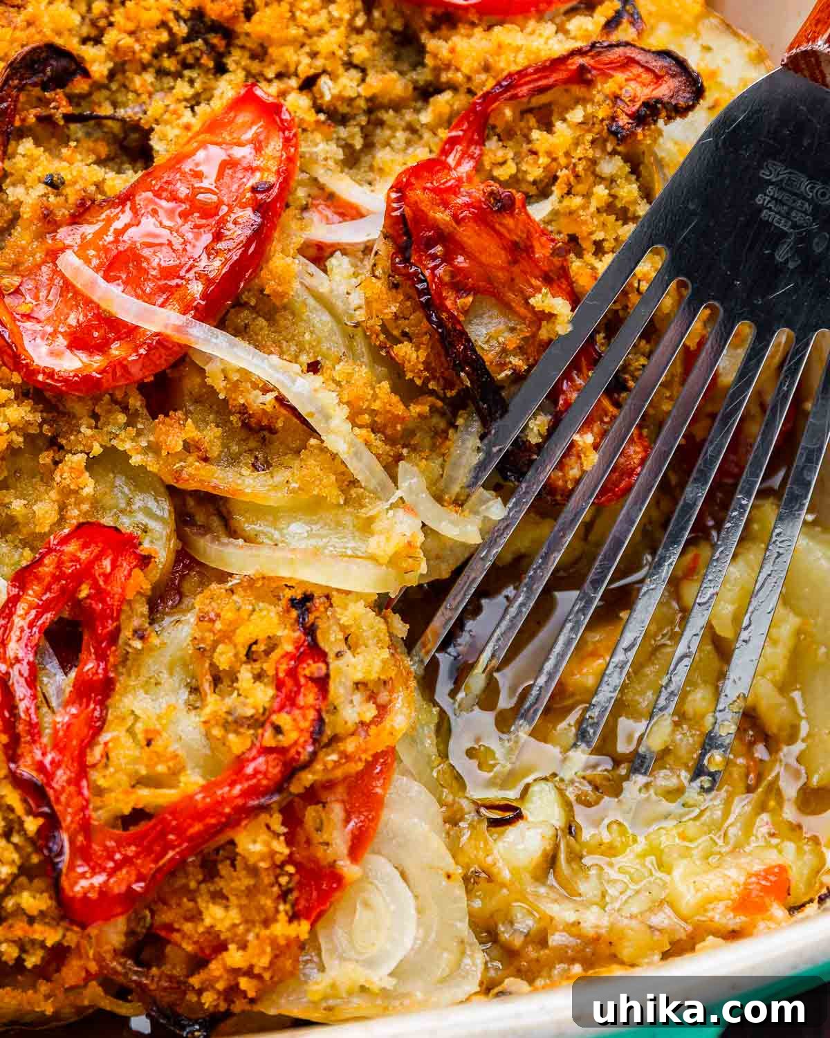 Hearty Italian Potato Gratin 2 Golden-brown Italian potato casserole in a baking dish, ready to be served with a spatula.