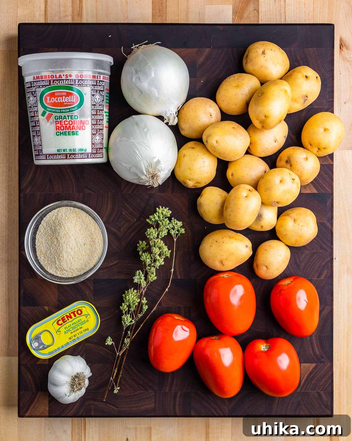 Hearty Italian Potato Gratin 3 A collage of raw ingredients for Italian potato casserole: Pecorino cheese, onions, potatoes, breadcrumbs, anchovies, garlic, oregano, and tomatoes.