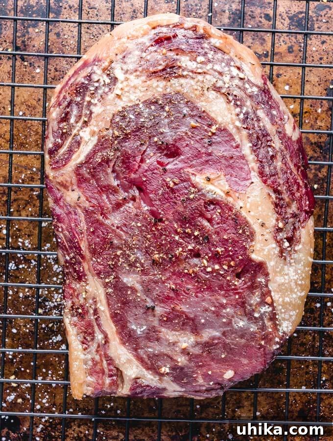 Reverse Seared Ribeye Steaks - sipandfeast.com #reversesear #ribeye #steak #dinner Ribeye steak removed from oven before reverse searing.