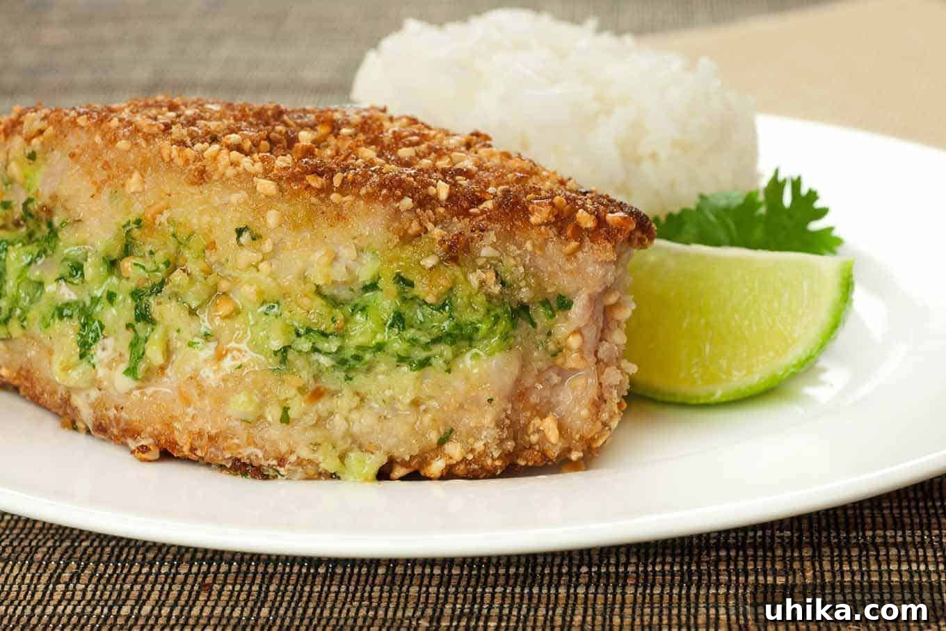 Thai Peanut Crunch Chops 2 Crispy Thai-Style Peanut and Panko-Crusted Pork Chops served with jasmine rice and vibrant snap peas