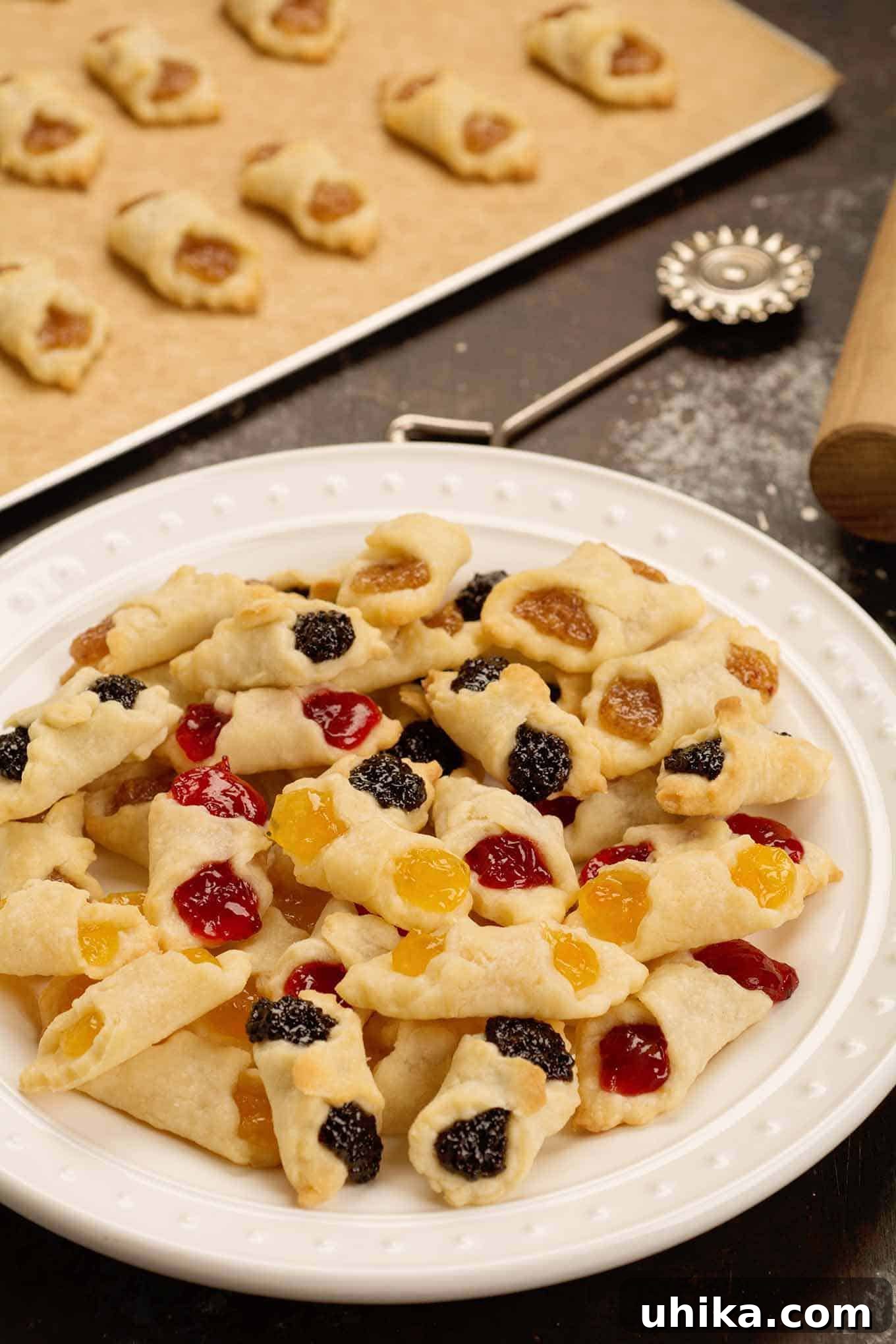 Generations of Hungarian Kiffles 3 A serving plate piled with fresh baked Hungarian kiffles in assorted flavors of cherry, poppy, almond, and apricot.