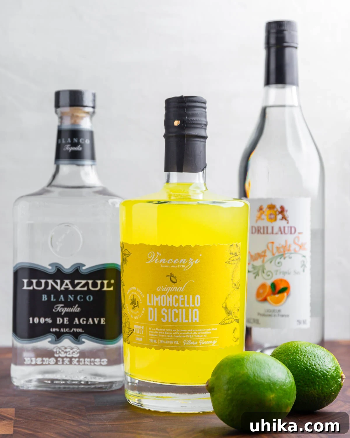 The Amalfi Coast Margarita 3 Ingredients shown: tequila, limoncello, triple sec, and limes.