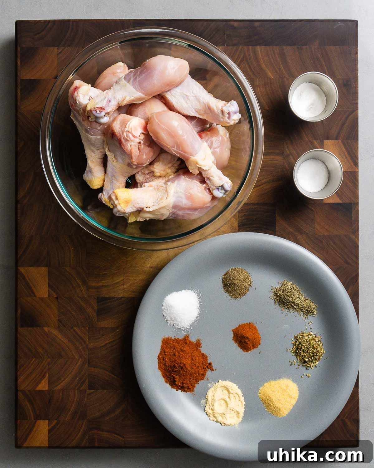 Effortless Cajun Roasted Drumsticks 3 Ingredients shown: bowl of chicken legs, baking powder, salt, and spices for homemade Cajun seasoning.