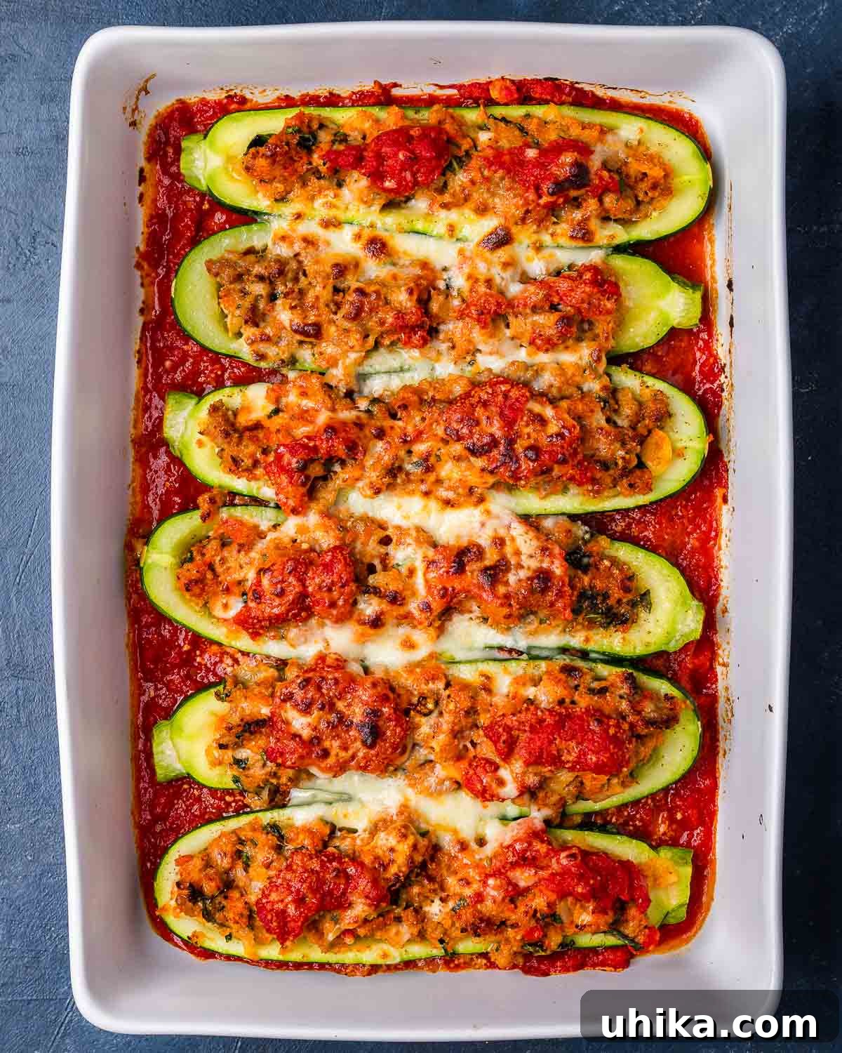 Sausage Stuffed Zucchini Bake 8 Overhead shot of sausage stuffed zucchini boats in white baking dish.