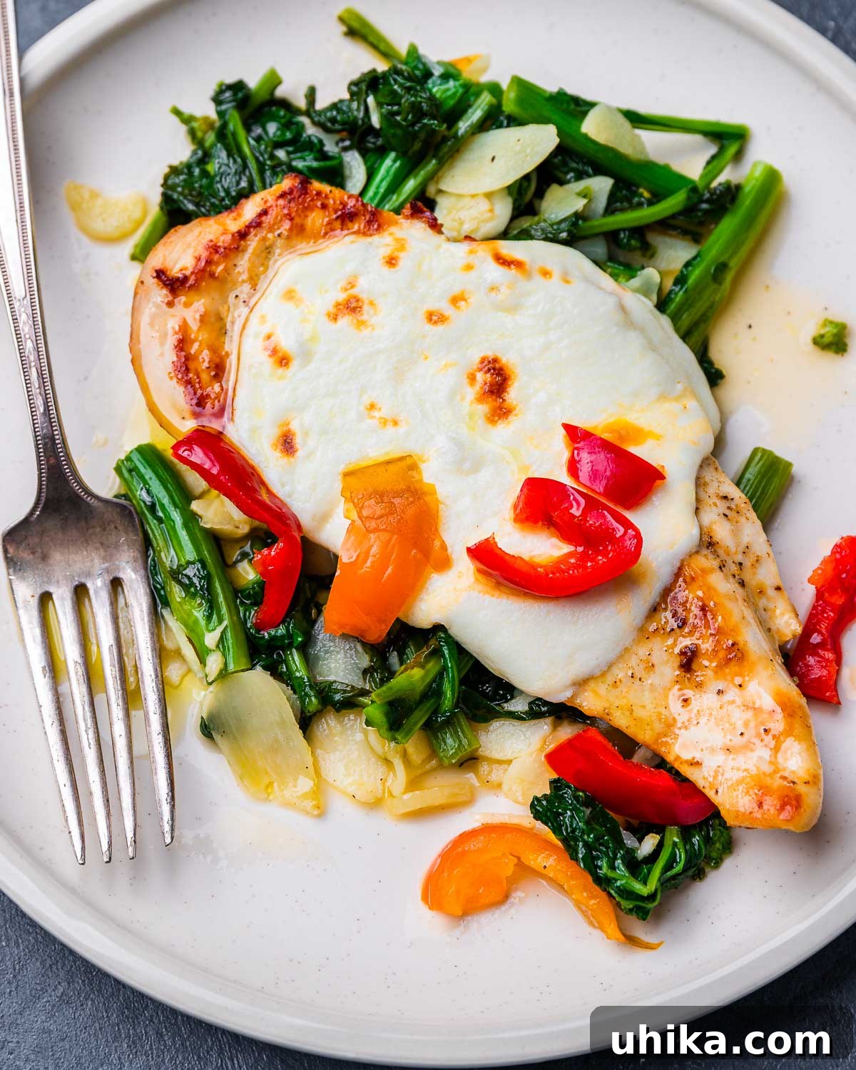Pan-Seared Chicken with Garlicky Broccoli Rabe 6 Chicken and broccoli rabe with cherry peppers in white plate.