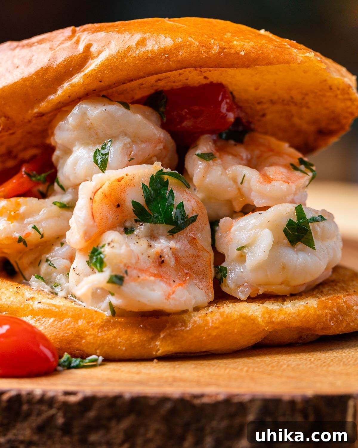 A single, perfectly golden shrimp scampi roll presented on a rustic wooden board, showcasing its vibrant filling.