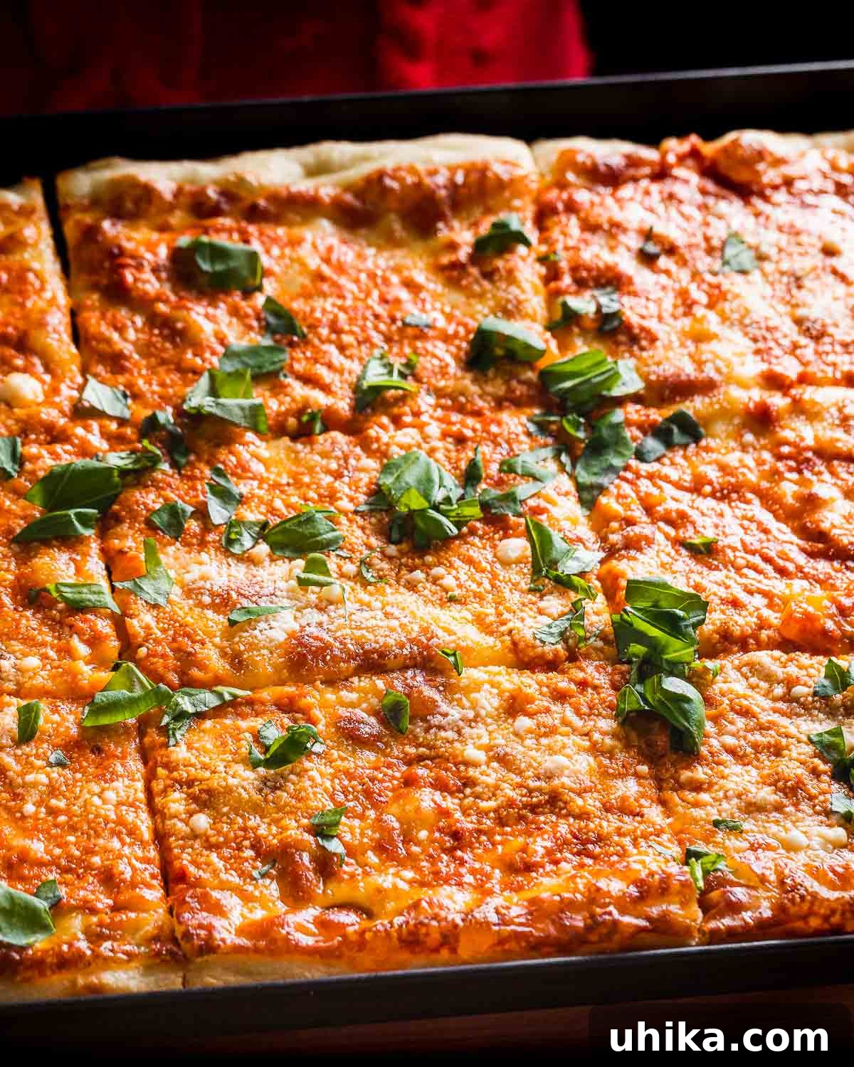 Rose Vodka Pizza 7 A fully baked Vodka Sauce Grandma Pizza resting in its pan, showcasing its crispy crust and vibrant toppings.