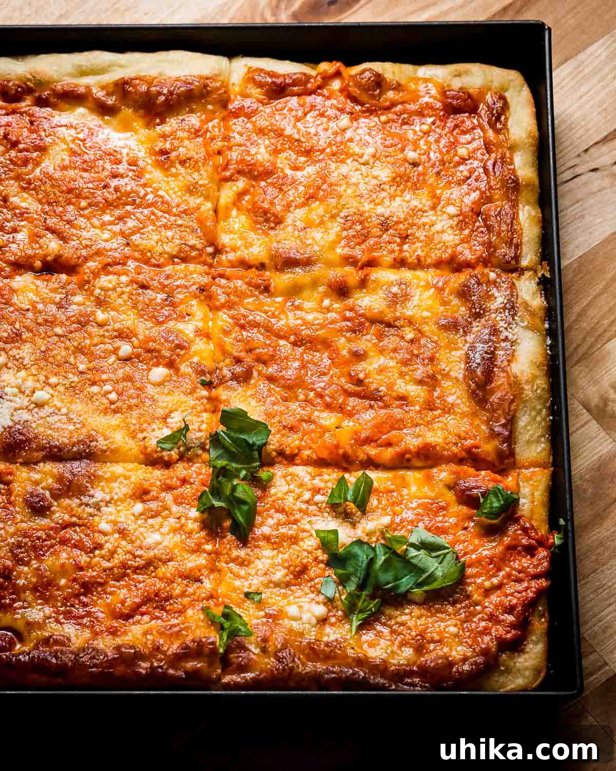 Rose Vodka Pizza 8 A beautifully captured image of Vodka Sauce Grandma Pizza in its pan, ready to be sliced and served, emphasizing its rich texture and color.
