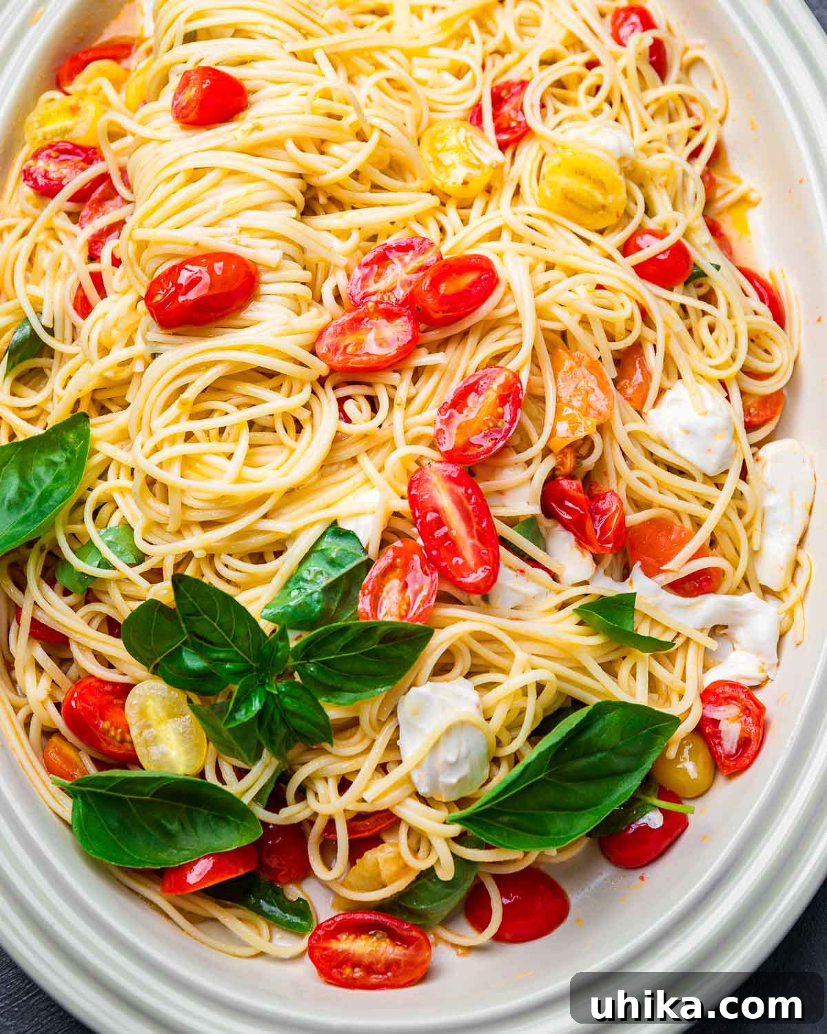 Quick & Fresh Caprese Pasta 6 Caprese pasta served in a large platter, garnished with fresh basil.