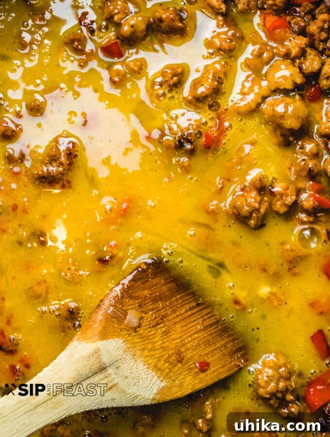Chorizo and Eggs - sipandfeast.com #breakfastrecipes #eggrecipes #brunch #chorizo Eggs added to the pan.
