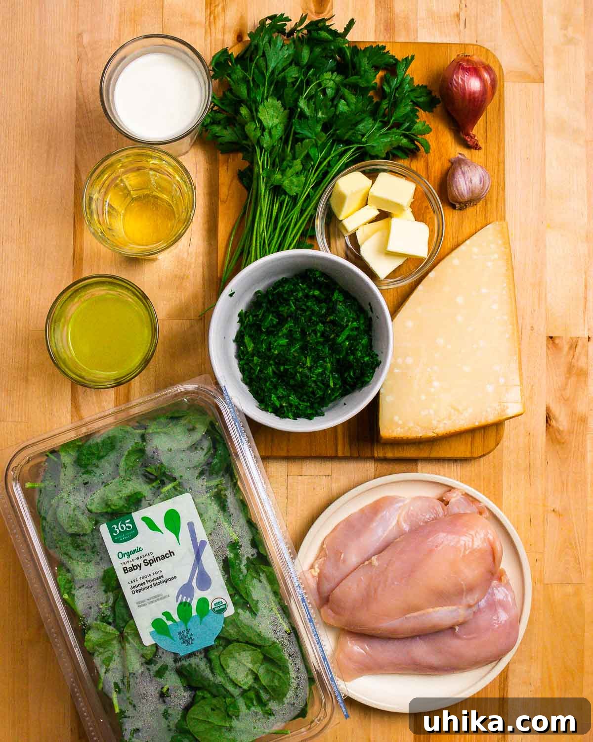 Creamy Tuscan Chicken 3 Assortment of fresh ingredients for Chicken Florentine, including heavy cream, white wine, chicken stock, fresh parsley, spinach, butter, shallot, garlic, Parmigiano Reggiano, and chicken breasts.