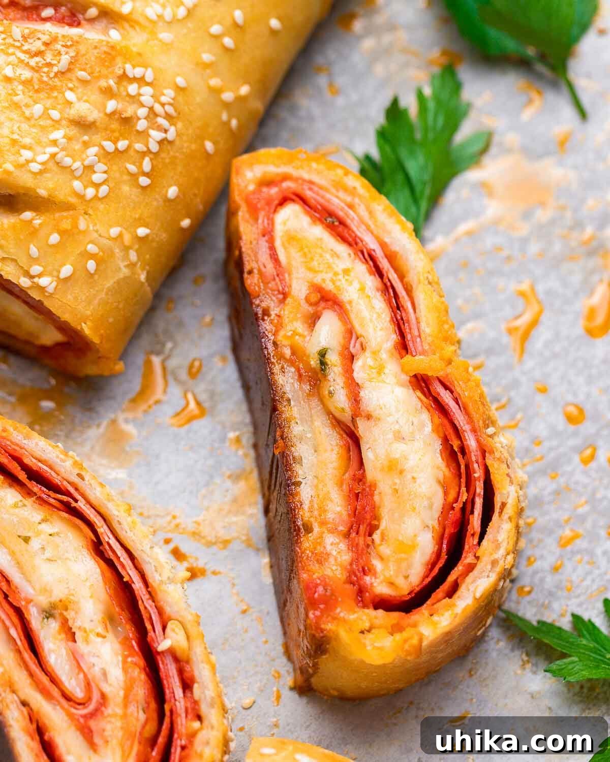 Mount Stromboli 6 Closeup shot of a single slice of baked Stromboli, showing the layers of meat and cheese inside.