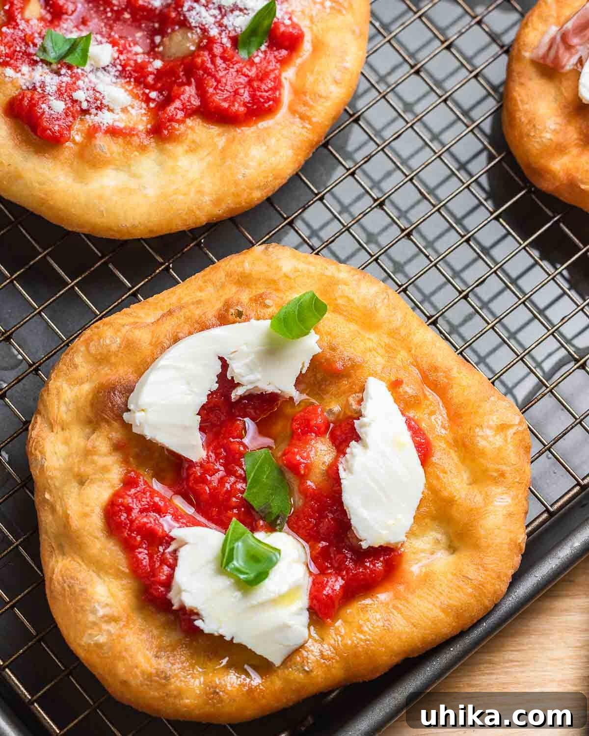 Golden Fried Pizza 2 Pizza fritta with tomato, mozzarella, and basil.
