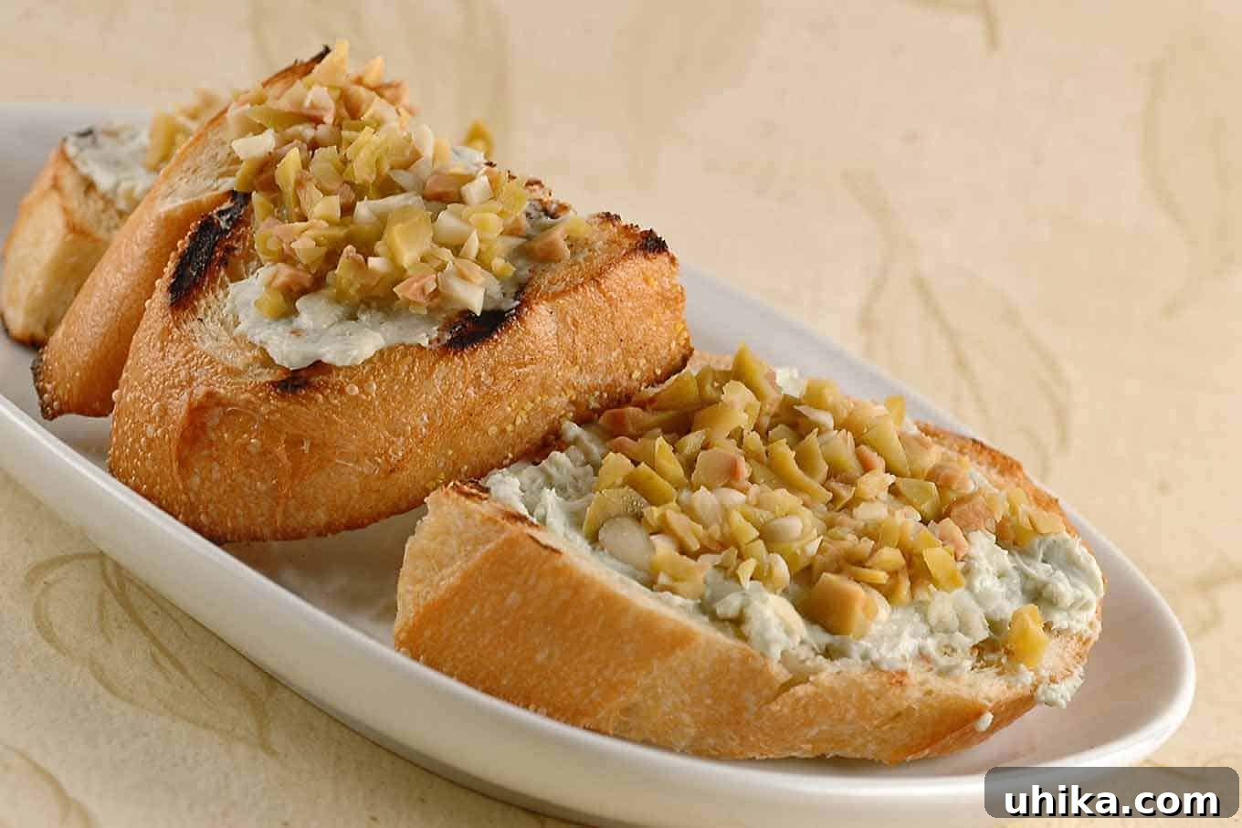 Artisan Gorgonzola Olive Garlic Bruschetta 2 Delicious Gorgonzola, Olive and Garlic Bruschetta appetizer on toasted bread, perfect for entertaining.