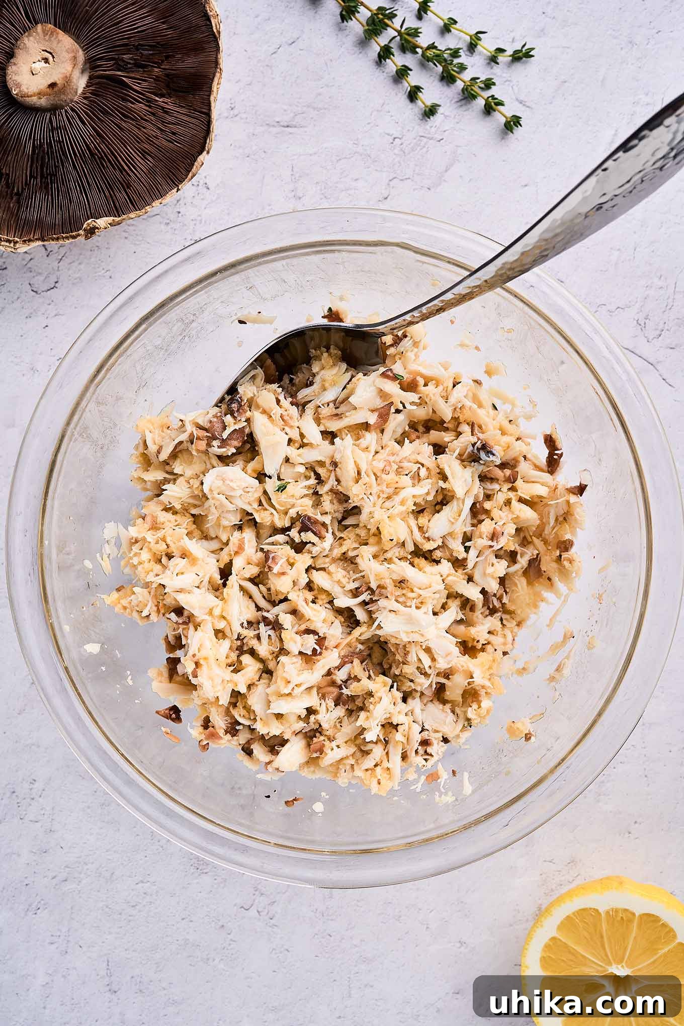 Elegant Crab Stuffed Portobello Caps 4 A large mixing bowl filled with a delightful crab stuffing mixture, featuring lump crabmeat, panko, and various seasonings, all prepared and ready to be gently added to portobello mushroom caps for baking.