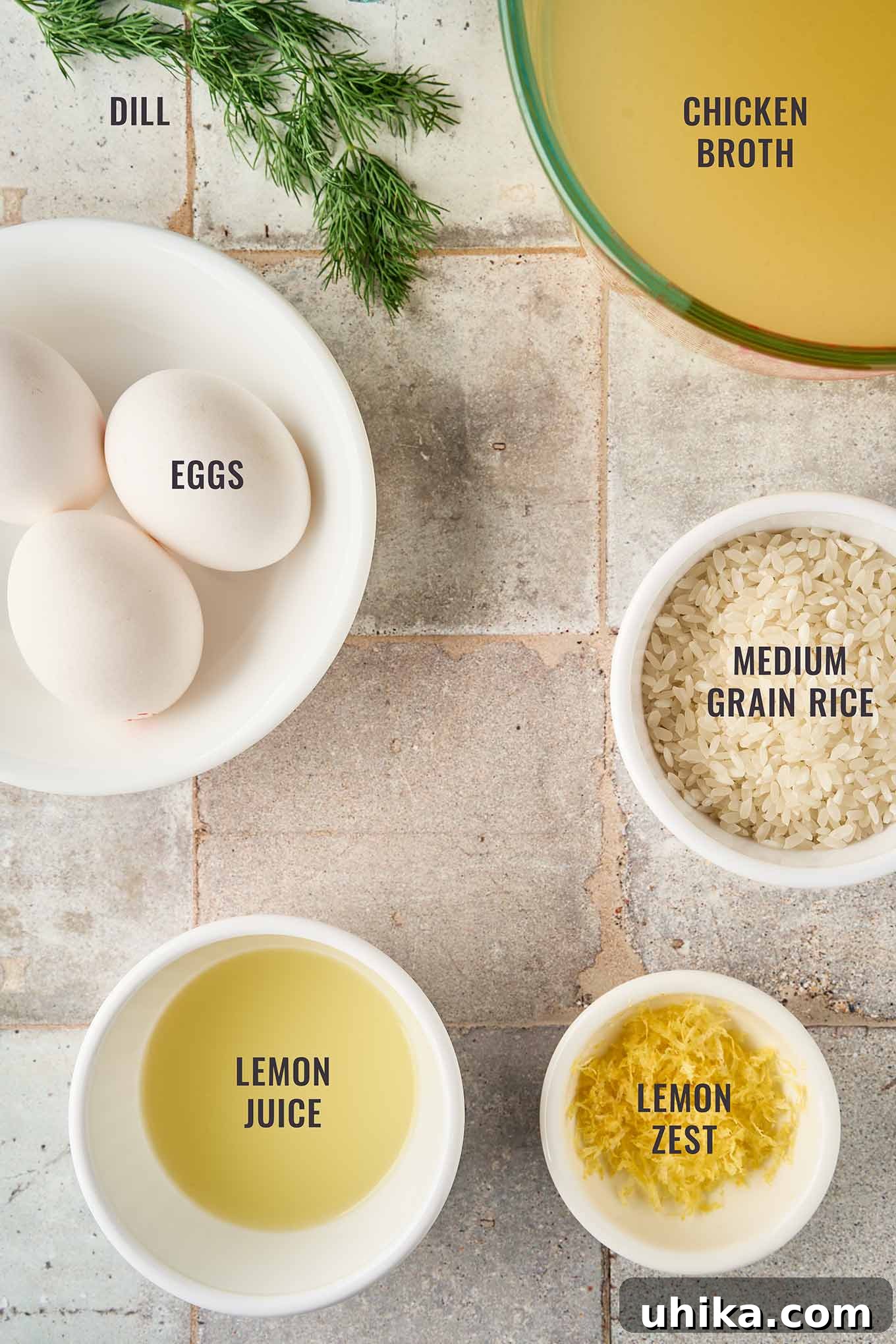 Golden Greek Avgolemono Soup 3 Key ingredients for crafting authentic Greek egg and lemon soup: fresh eggs, rich chicken broth, medium-grain rice, vibrant lemon juice and zest, and aromatic fresh dill.