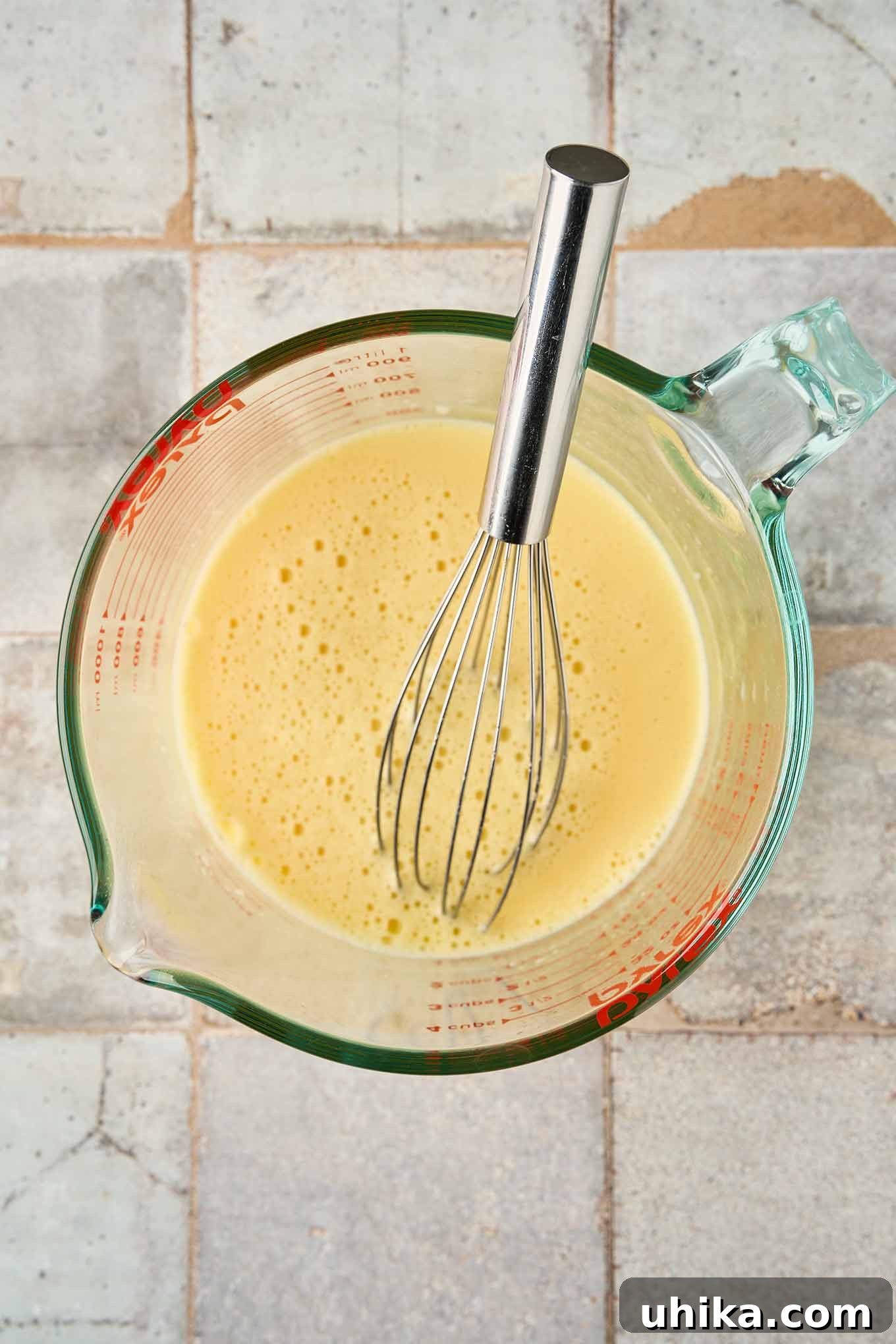 Golden Greek Avgolemono Soup 5 The smooth, pale, and creamy whisked egg mixture, perfectly tempered with hot broth and lemon, poised to be integrated into the Avgolemono soup.