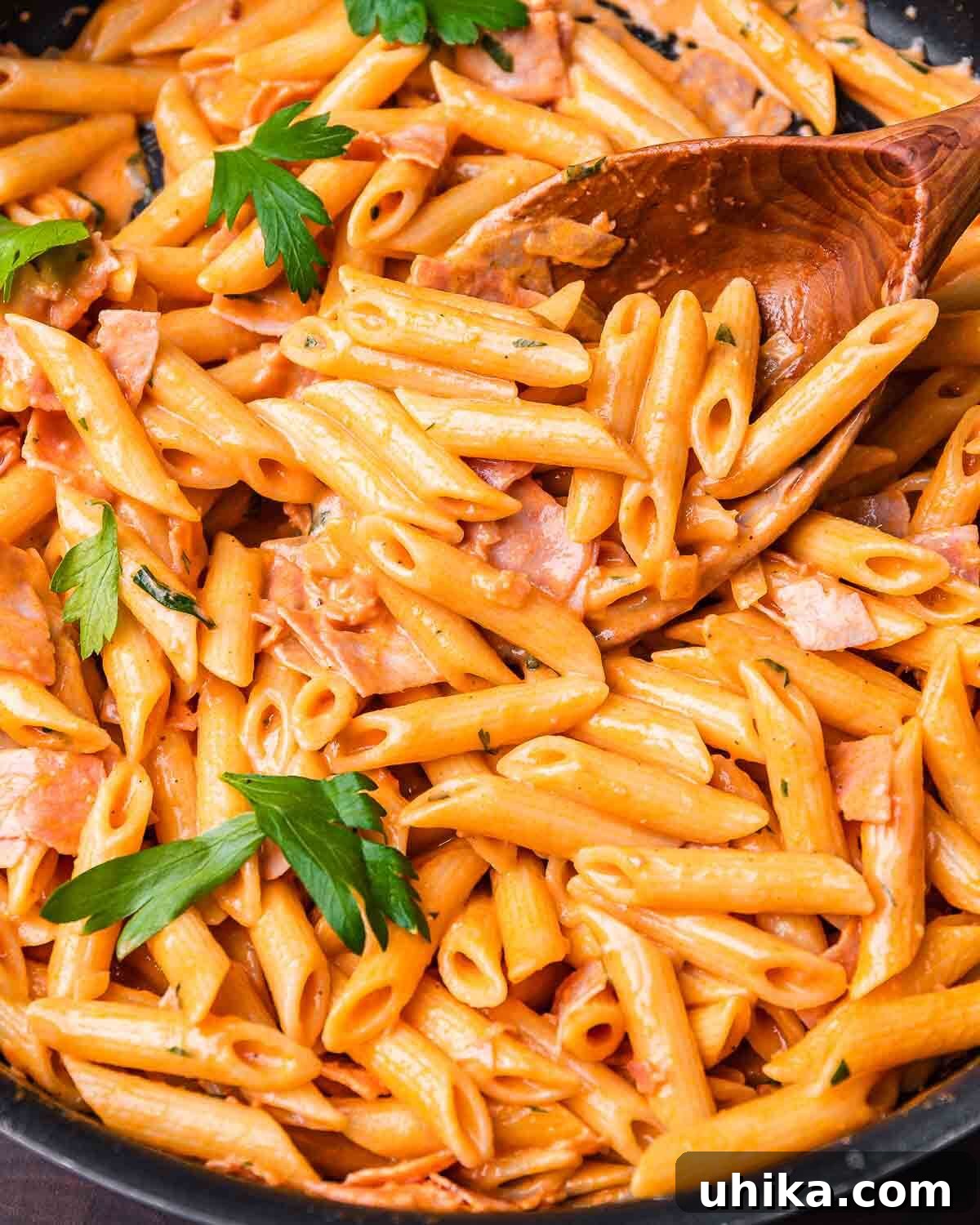 Penne al baffo in large pan, garnished with fresh parsley.