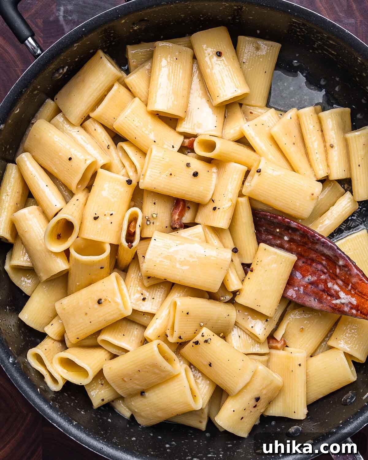 Roman Rigatoni with Cured Pork Cheek and Pecorino Cheese 2 Overhead shot of rigatoni alla gricia in black pan, highlighting its simple yet rich appearance.