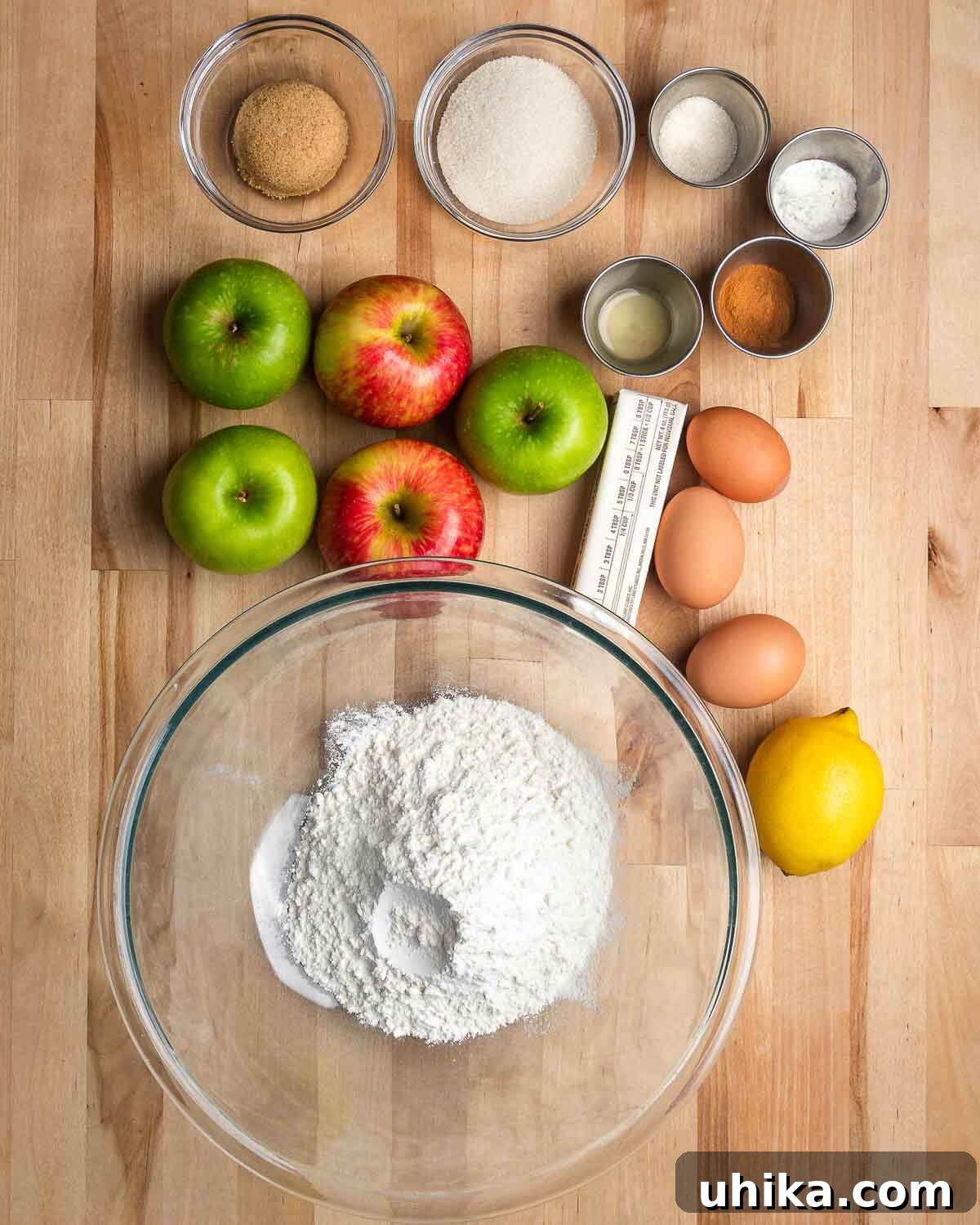 Rustic Apple Galette 3 Ingredients shown: brown sugar, sugar, cinnamon, baking powder, baking soda, vanilla extract, apples, eggs, butter, lemon, and flour.
