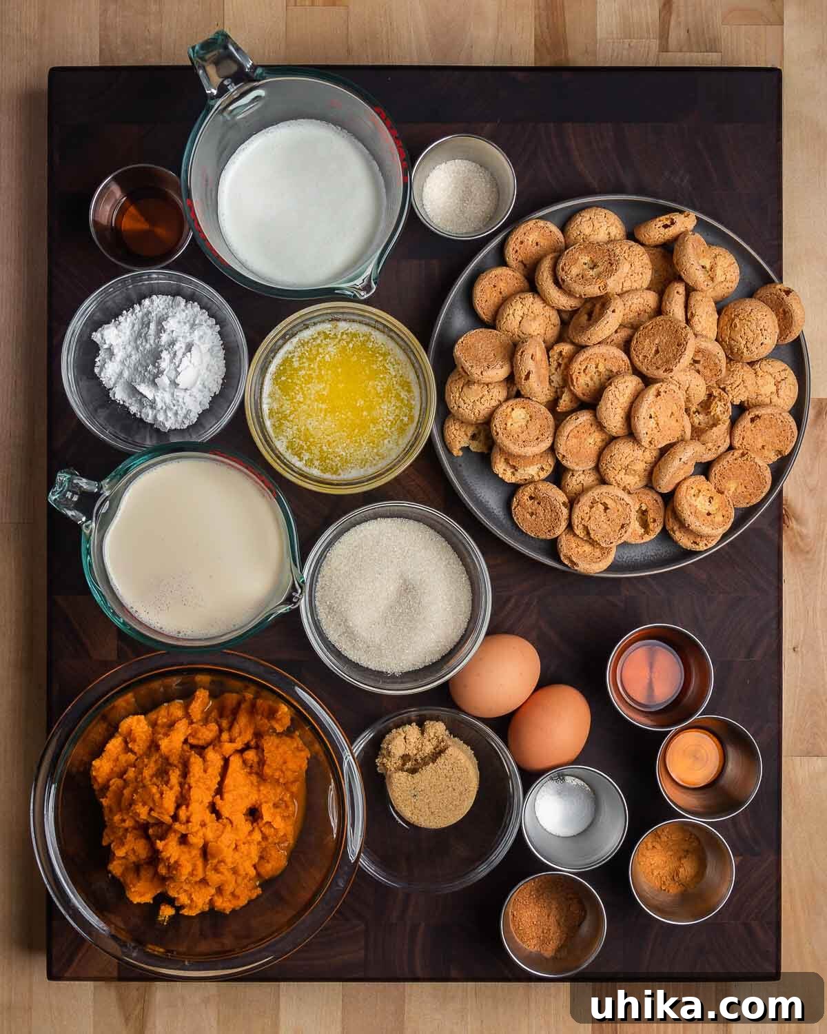 Amaretto Kissed Pumpkin Pie 3 Overhead shot of all ingredients for amaretti crust, pumpkin pie filling, and amaretto whip cream neatly arranged on a wooden table.