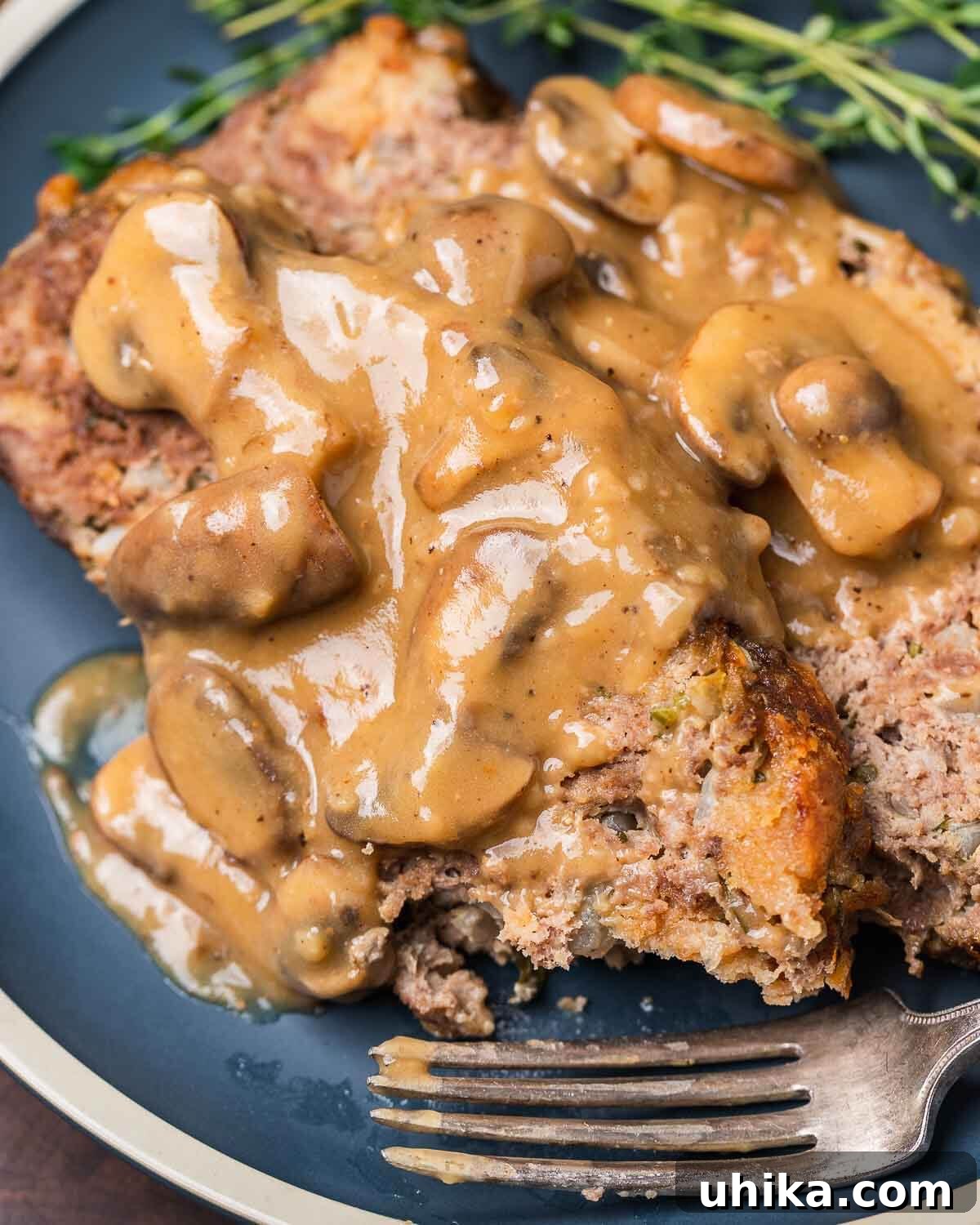 Ultimate Comfort Meatloaf with Rich Gravy 7 Plated meatloaf with gravy, showcasing a generous serving ready to be enjoyed.