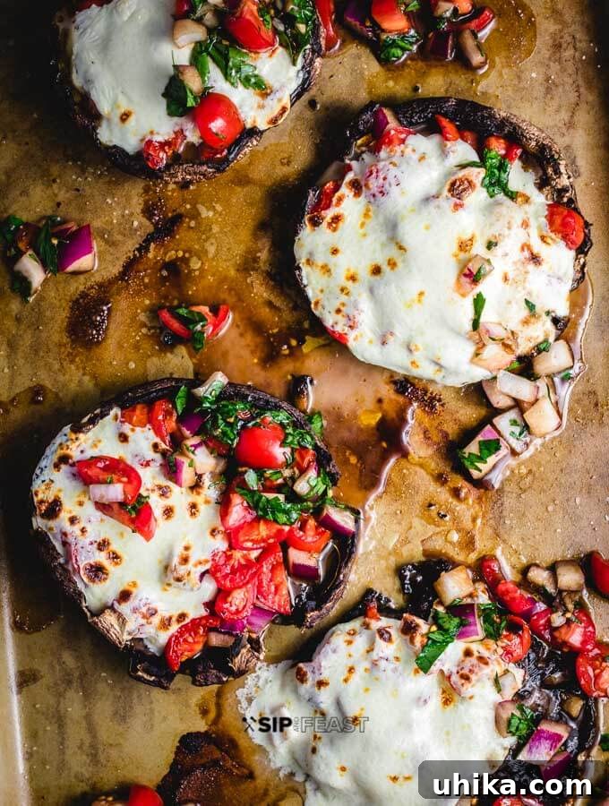 Baked Portobello Mushrooms With Bruschetta And Mozzarella - A perfect Italian appetizer or side dish. Baked Portobello Mushrooms with fresh bruschetta and melted mozzarella cheese, garnished with parsley.
