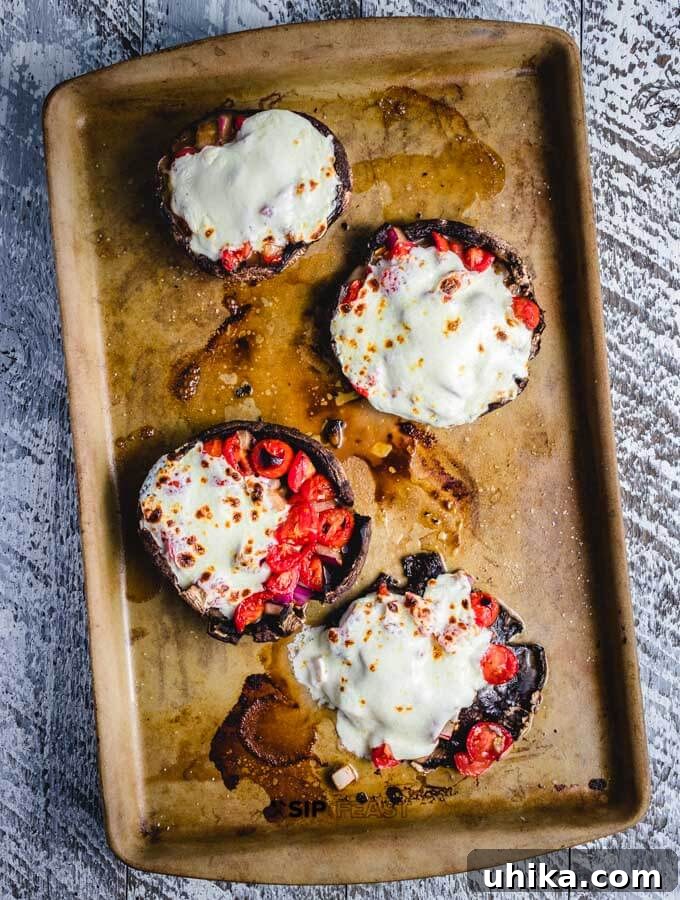 Perfectly broiled mozzarella on portobello mushrooms. Broiled fresh mozzarella cheese on baked portobello mushrooms, golden and bubbly.