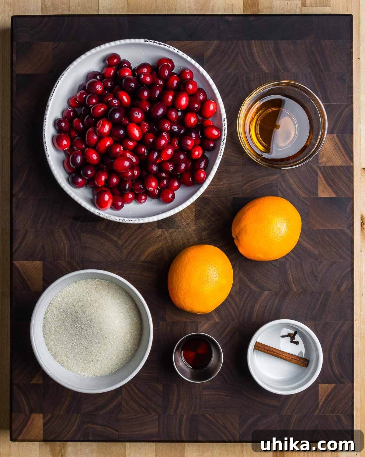 Ruby Red Cranberry Zing 3 Key ingredients for homemade cranberry sauce: fresh cranberries, orange liqueur, fresh oranges, granulated sugar, vanilla extract, whole cloves, and a cinnamon stick.