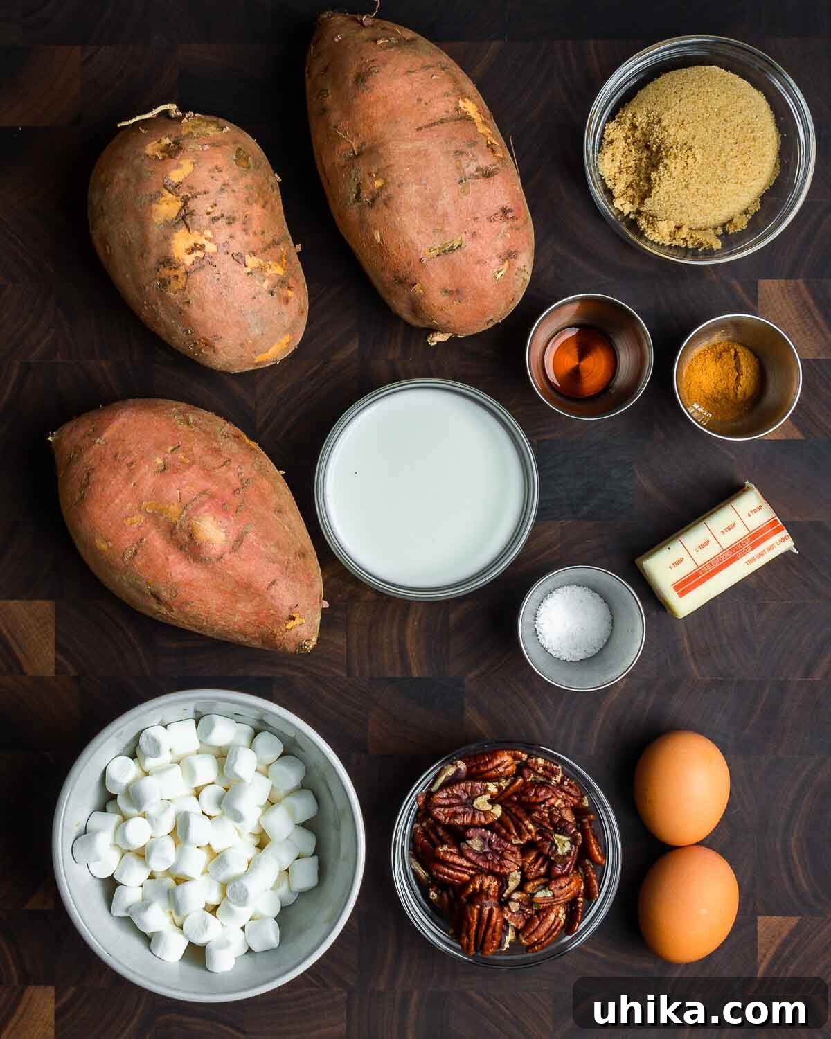 Sweet Potato Cloud with Pecan Crunch 3 Ingredients shown: sweet potatoes, brown sugar, vanilla, cinnamon, milk, salt, butter, marshmallows, pecans, and eggs.