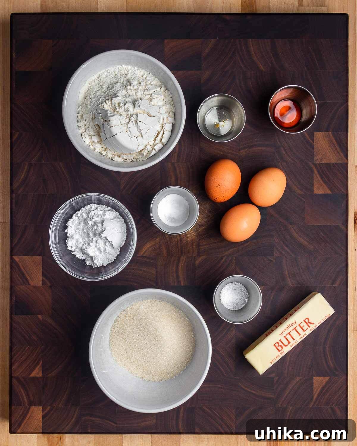 Crisp Italian Delights 3 Ingredients for pizzelle displayed: flour, anise extract, vanilla extract, powdered sugar, baking powder, eggs, sugar, salt, and butter, neatly arranged for clarity.