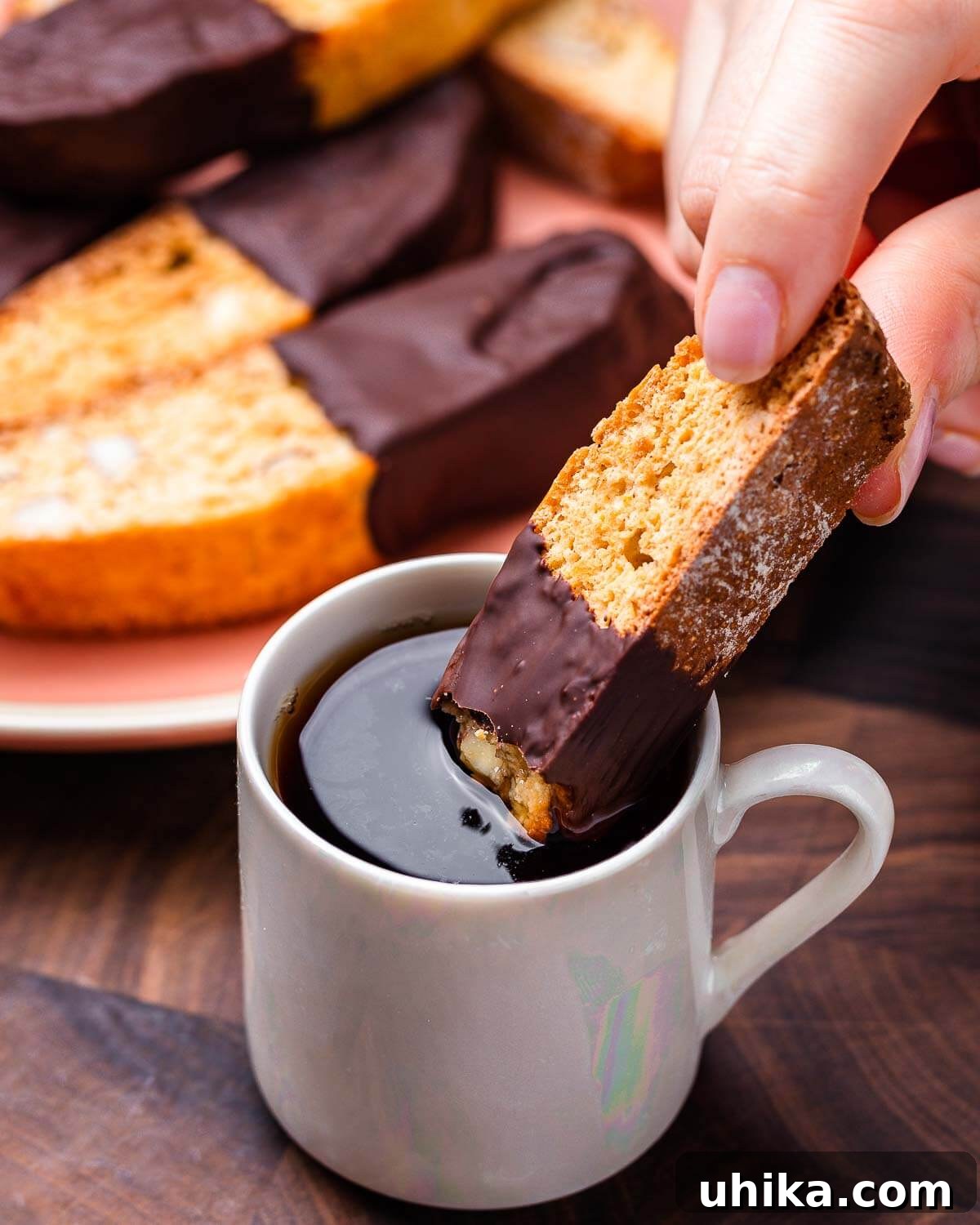 Twice-Baked Almond Delights 10 Hand dipping almond biscotti into coffee.