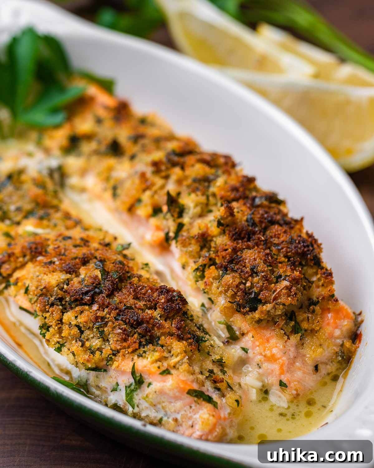 Golden Oregano Crusted Salmon 9 A close-up of a small plate of Salmon Oreganata, with fresh lemon and parsley in the background.