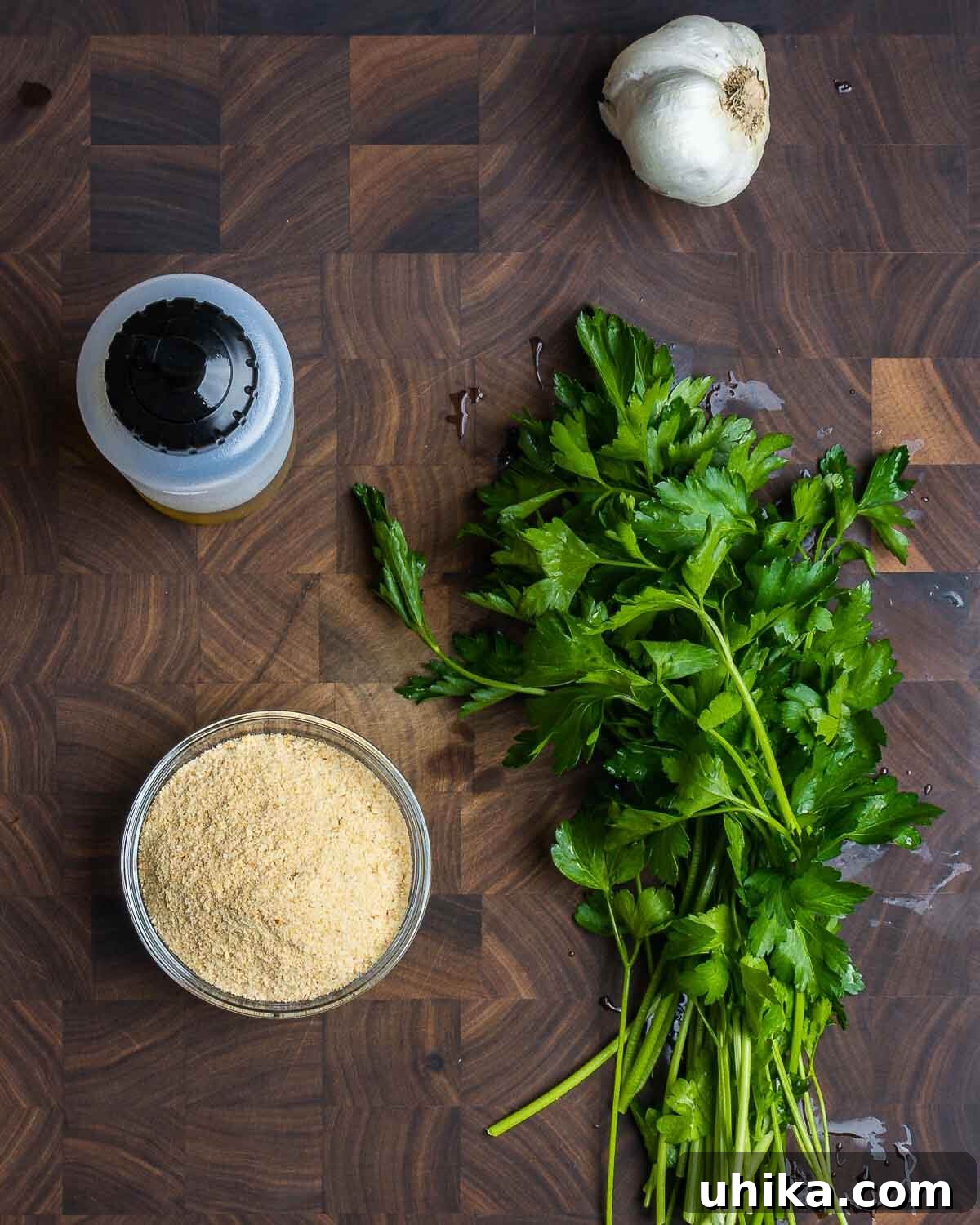 Easy Weeknight Clam Linguine 3 Seasoned breadcrumbs ingredients on walnut cutting board.