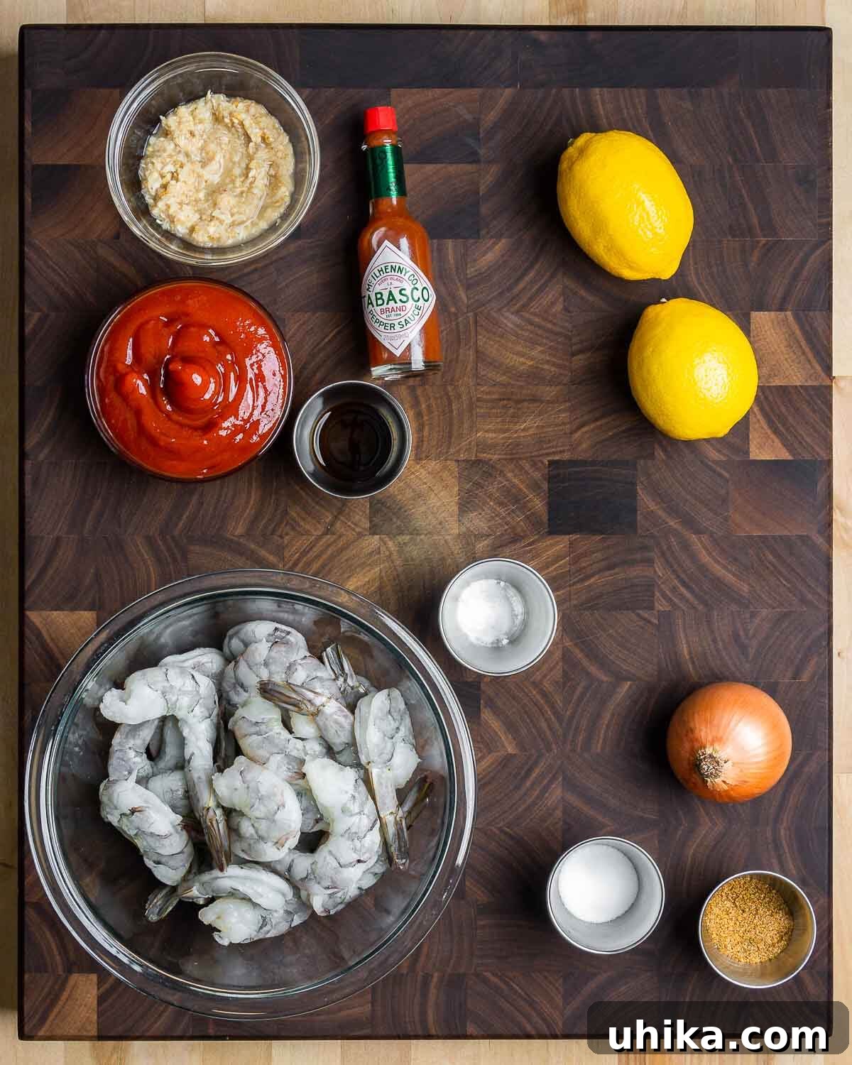 Chilled Prawn Perfection 3 Ingredients shown: horseradish, Tabasco, ketchup, Worcestershire sauce, lemons, shrimp, baking soda, salt, onion, and Old Bay seasoning.