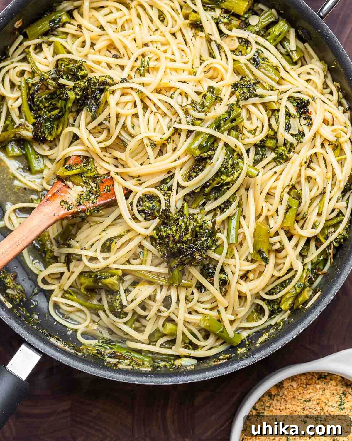 Overhead shot of roasted broccolini pasta on walnut cutting board.