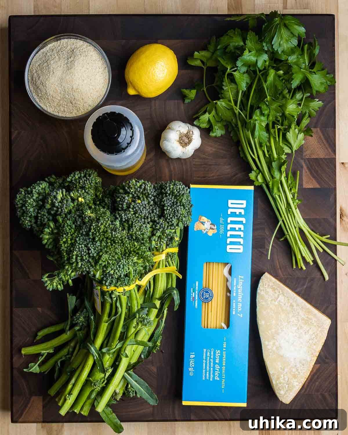 Ingredients shown: breadcrumbs, lemon, olive oil, garlic, parsley, broccolini, linguine, and Parmigiano Reggiano.