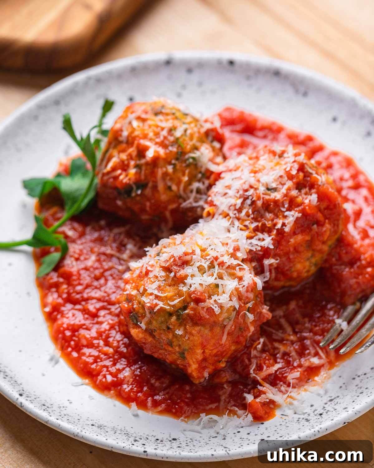Golden Bread Fritters 2 White plate with 3 meatless meatballs with grated cheese.