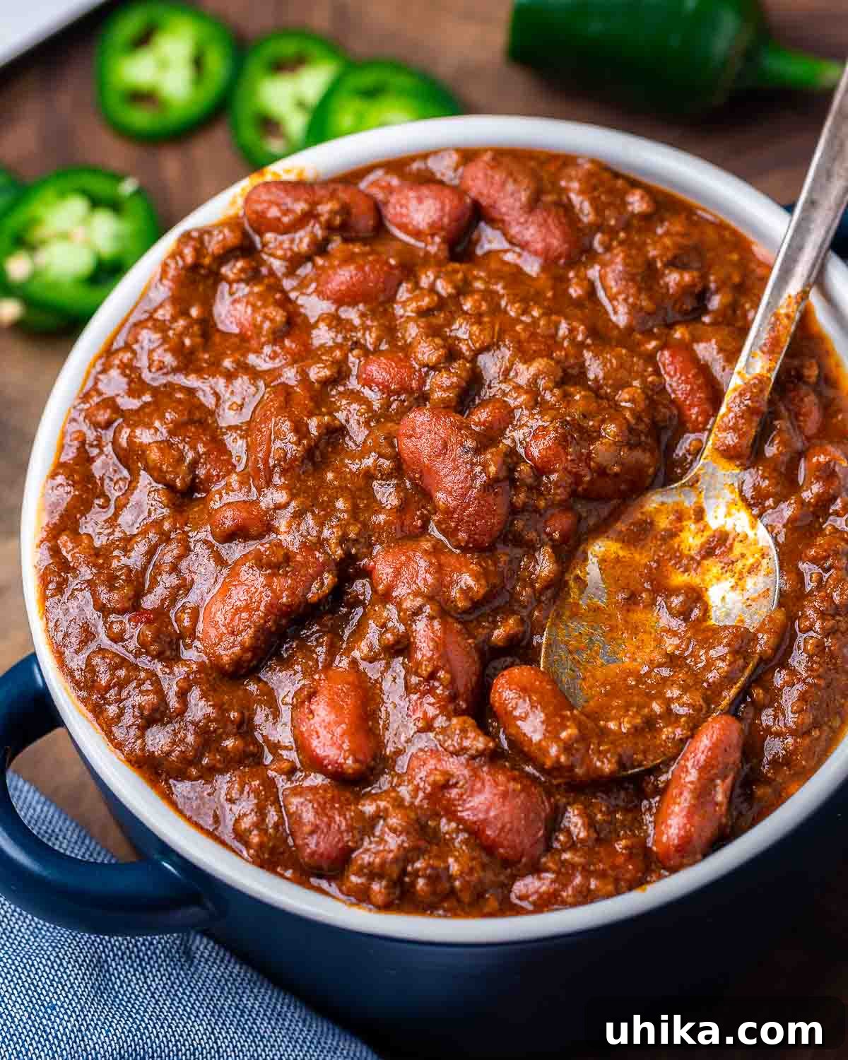 Hearty Classic Chili 2 Large bowl of chili with jalapenos in the background.