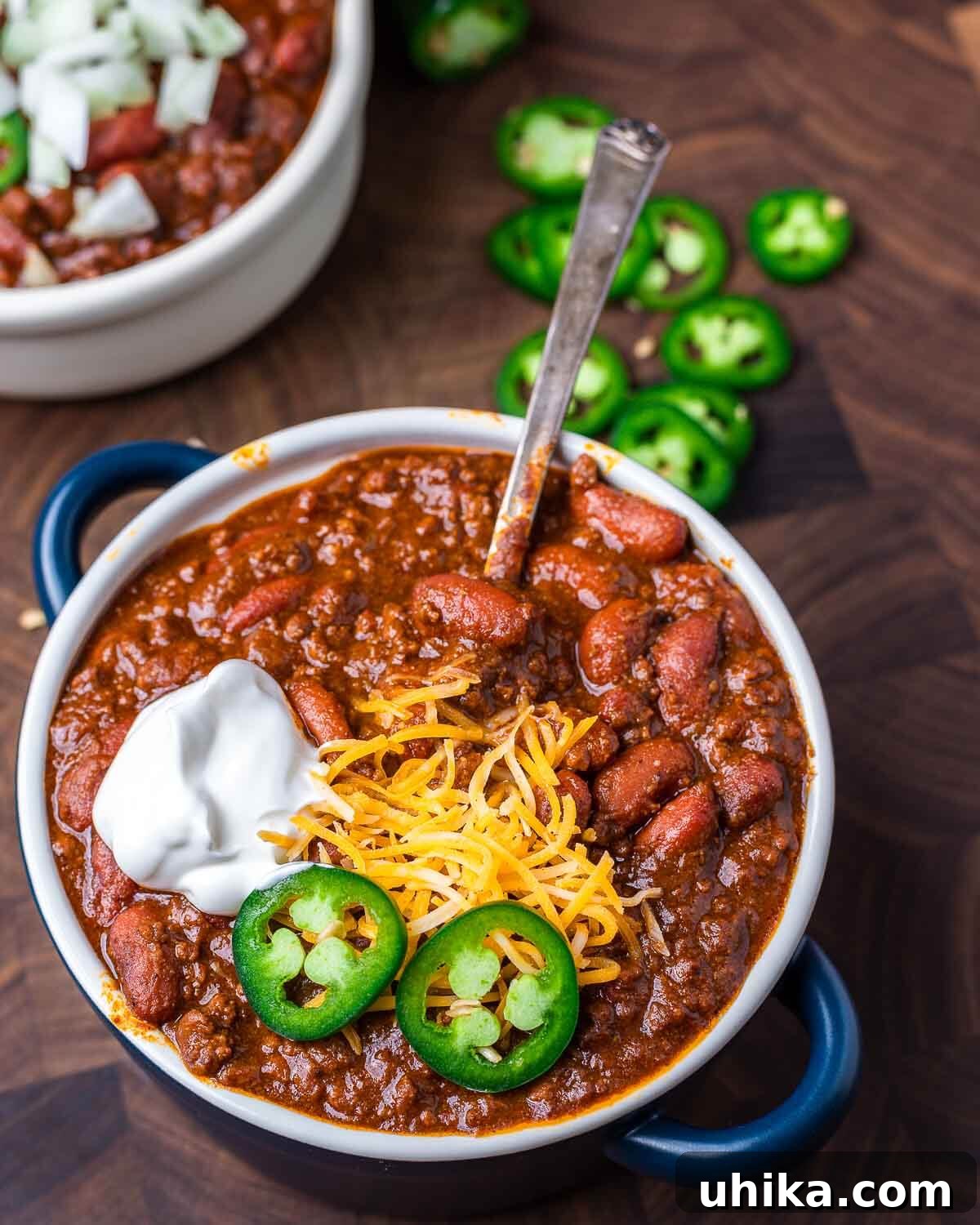 Hearty Classic Chili 8 Bowl of chili topped with jalapeno, cheddar cheese, and sour cream.