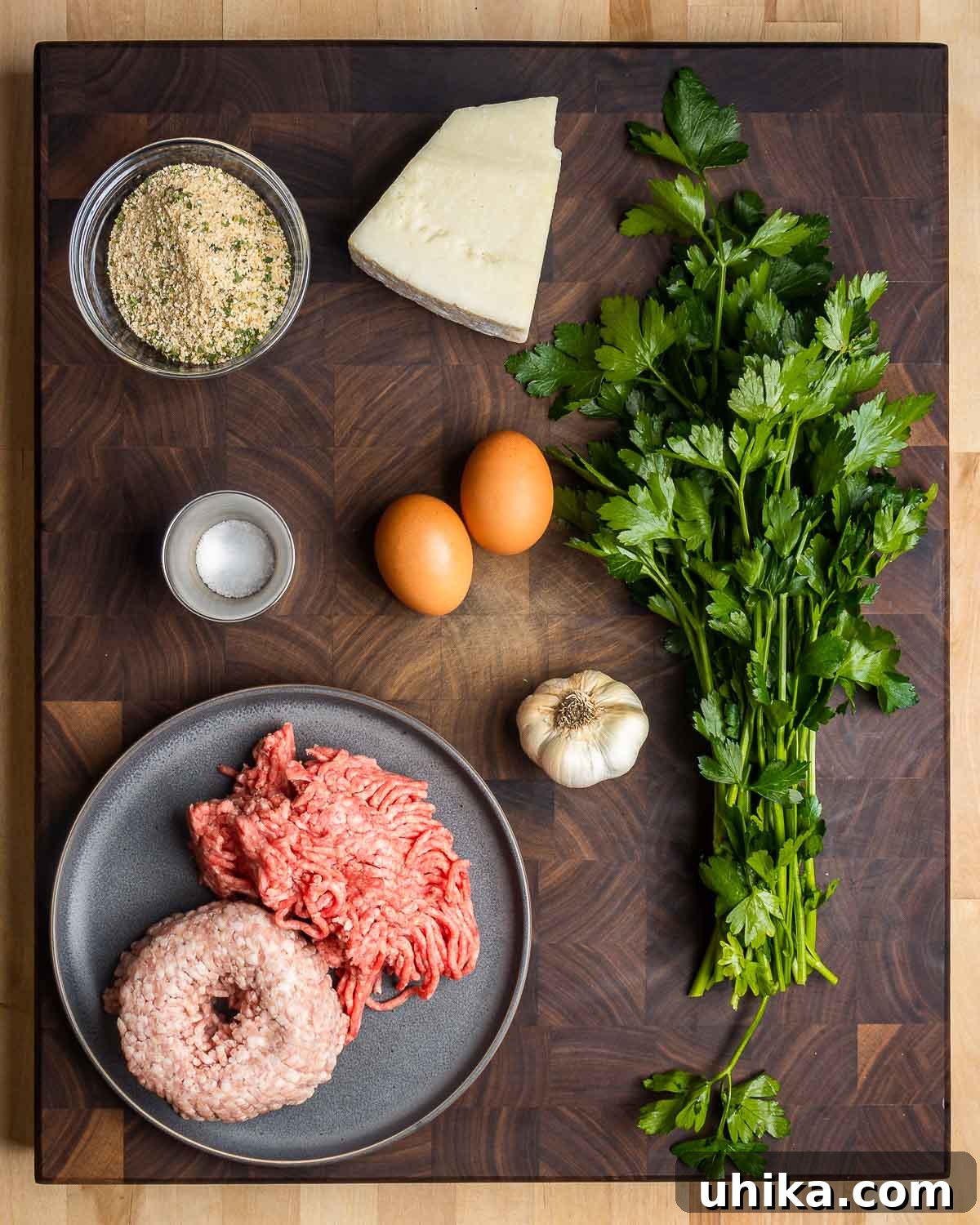 Cheesy Meatball Ziti Bake 3 A visual display of tiny meatball ingredients: breadcrumbs, Pecorino cheese, fresh parsley, salt, eggs, minced garlic, ground chuck, and ground pork.