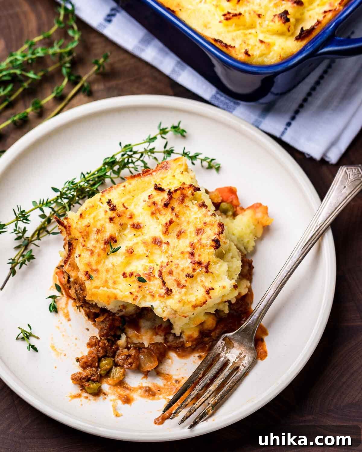 Homestyle Shepherds Pie 2 Shepherd's pie in white dish with baking dish in the background.