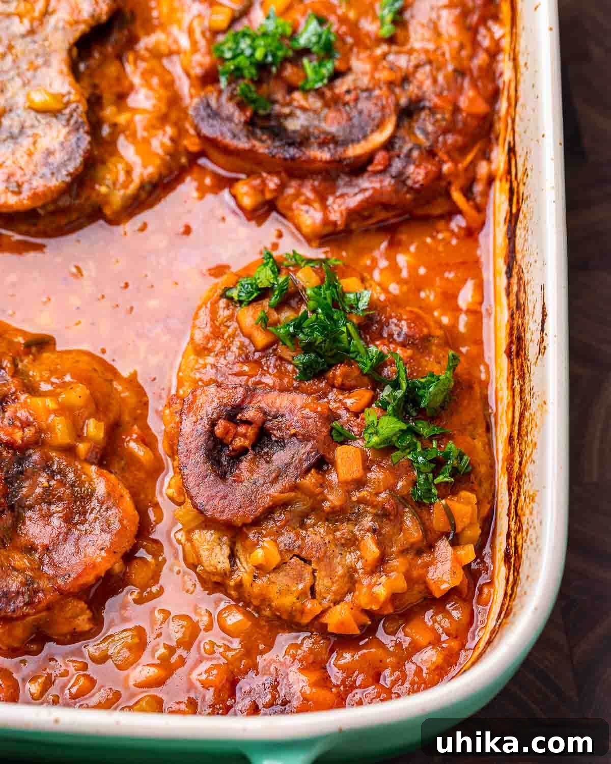 Osso Buco Hearty Braised Veal Shanks 8 Large baking dish with veal osso buco topped with gremolata.