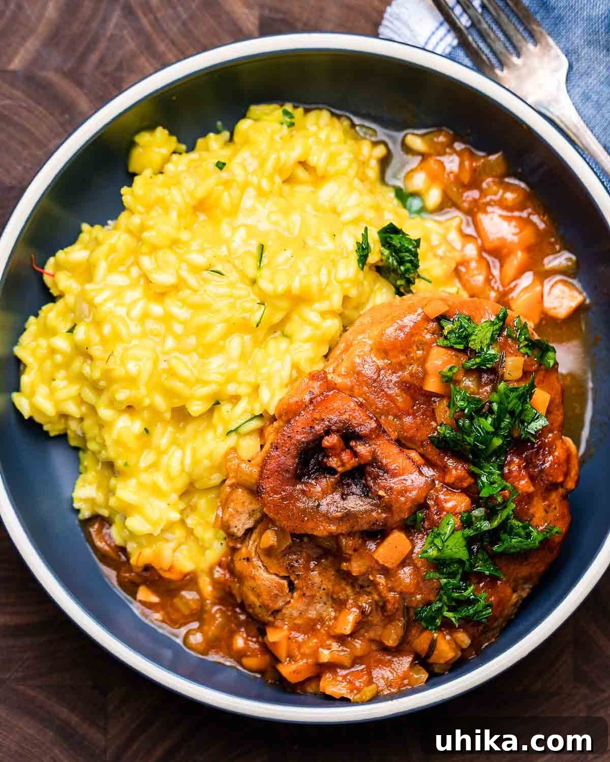 Osso Buco Hearty Braised Veal Shanks 9 Ovehead shot of osso buco with risotto in blue plate.